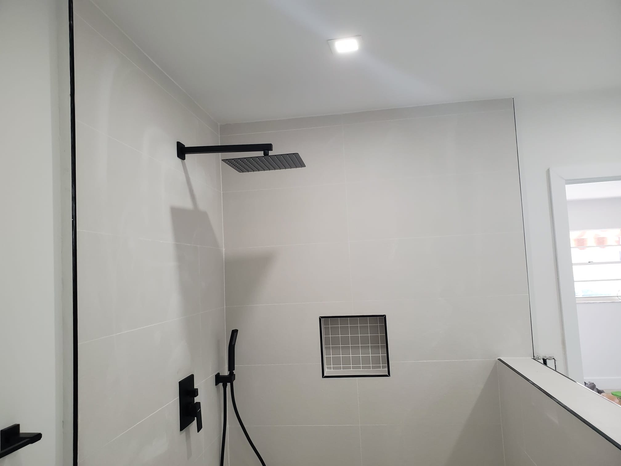 Luxury bathroom remodeling detail with custom shower, tub, tile, and refined finishes